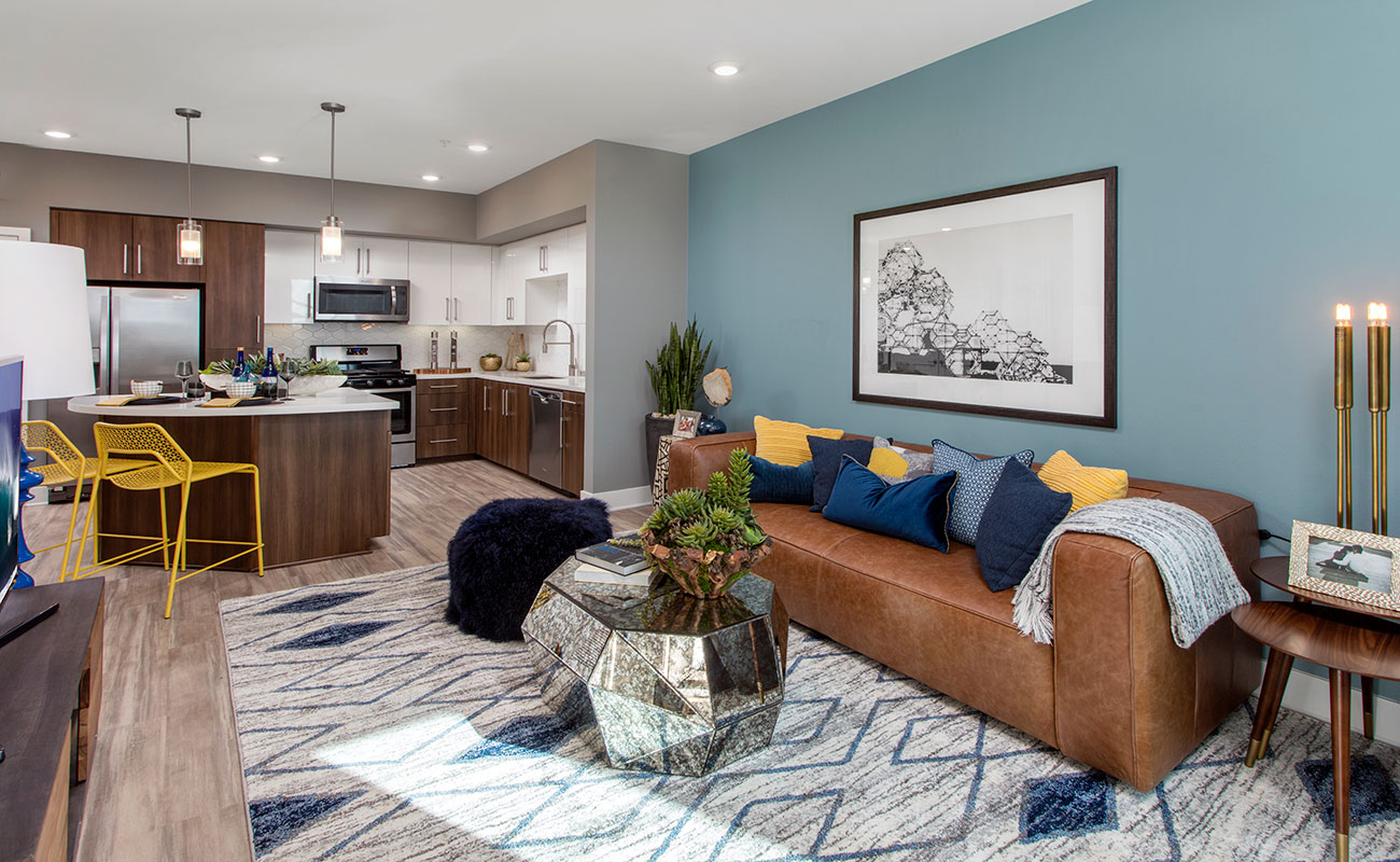 Apartments Irvine CA-The Royce Open Living Room with Hardwood-Styled Floors and Modern Lighting